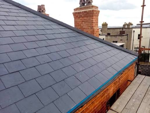 Roofer checking gutters in Cork